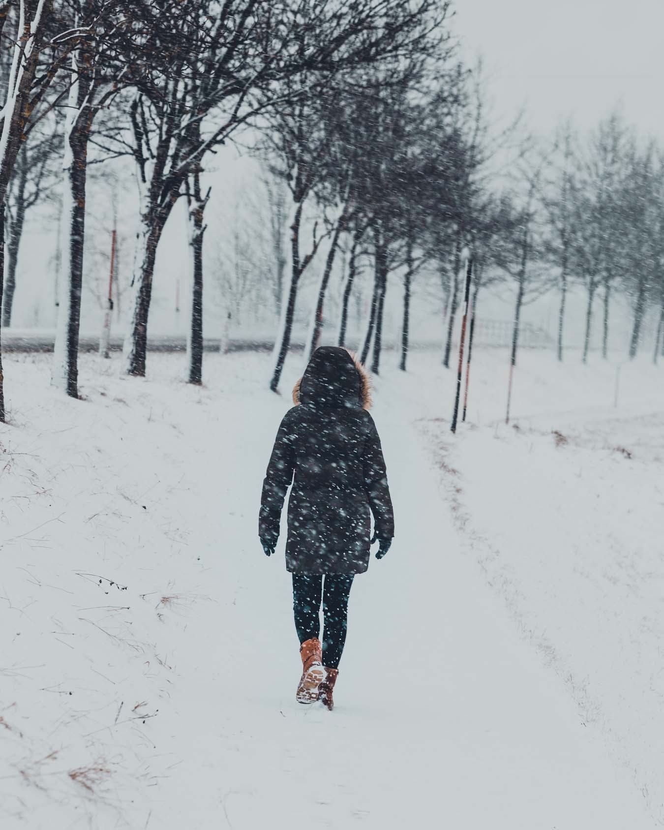 A person with warm winter clothing defies the blizzard