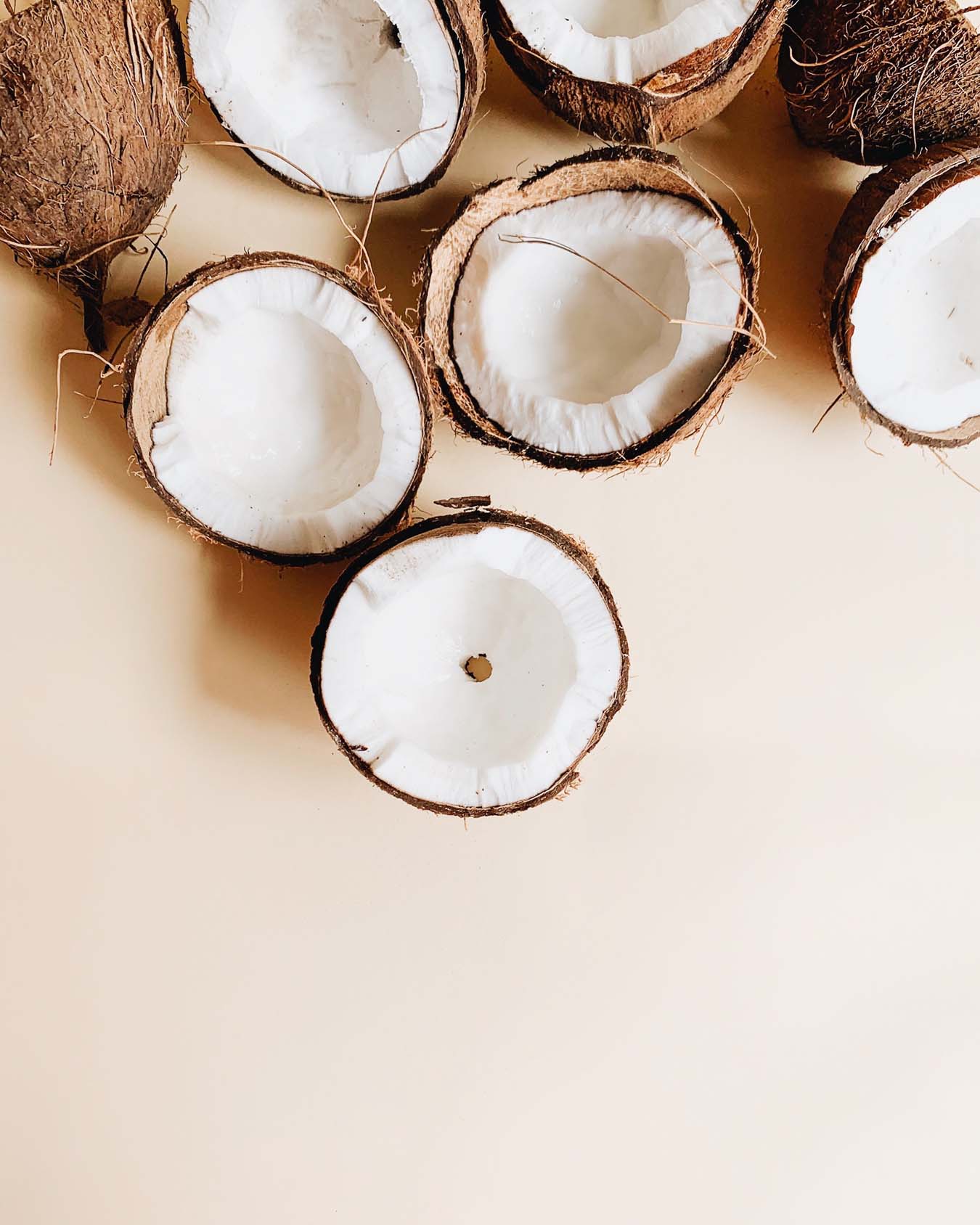 Opened coconuts lie on the floor.