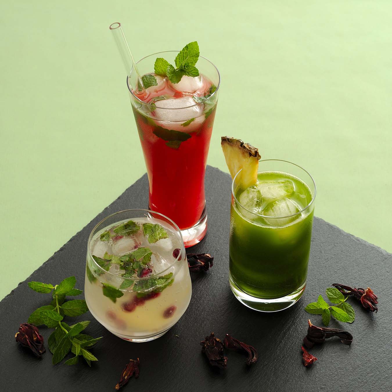 red, green and yellow cocktail on black plate