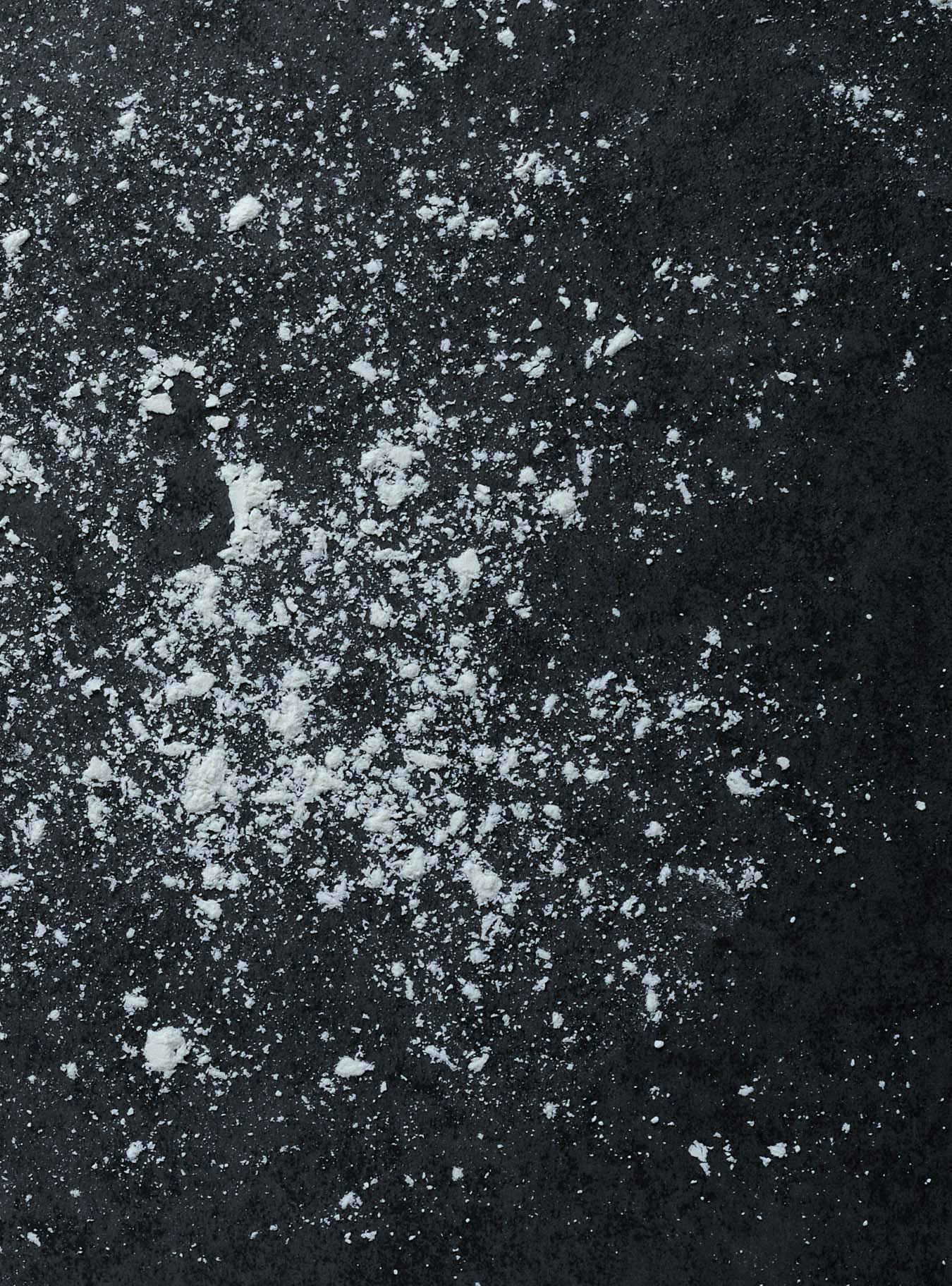white flour scattered over dark plate
