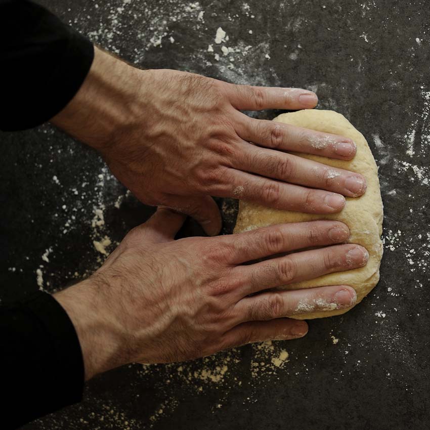 male hands knead dough