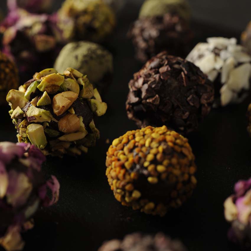 colorful truffles on black slate plate